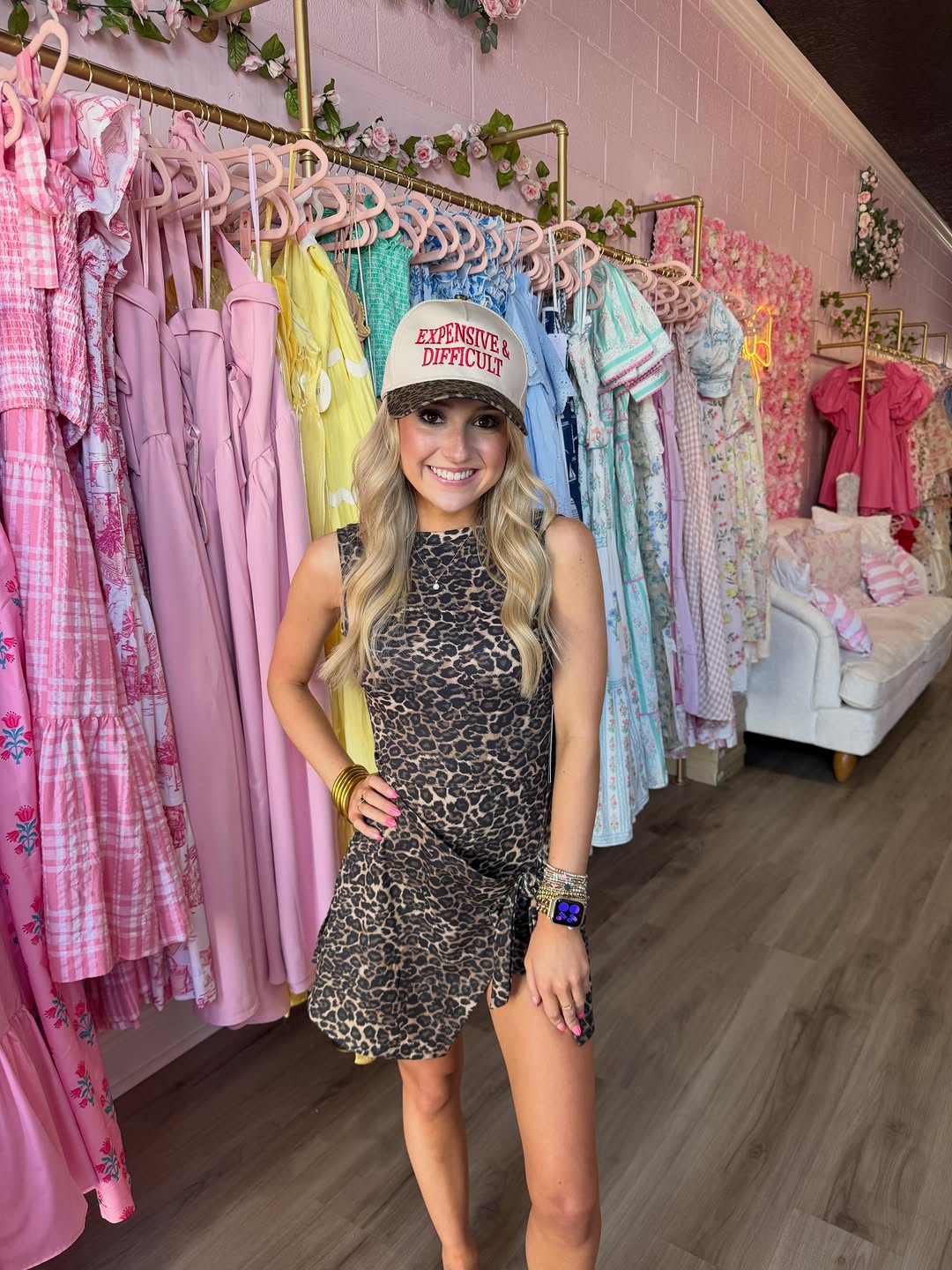 Kiley wearing a cheetah-print mini dress and trucker hat in the boutique